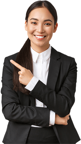 Smiling woman in black business suit with white shirt, pointing to the left with one hand while folding the other arm.