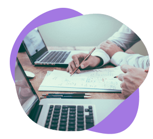 Writing notes next to a laptop.