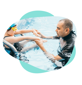 Instructor in water holding hands of a student.